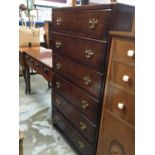 Oak tall boy chest with six drawers and brass handles on bracket feet 77cm wide, 139 cm high