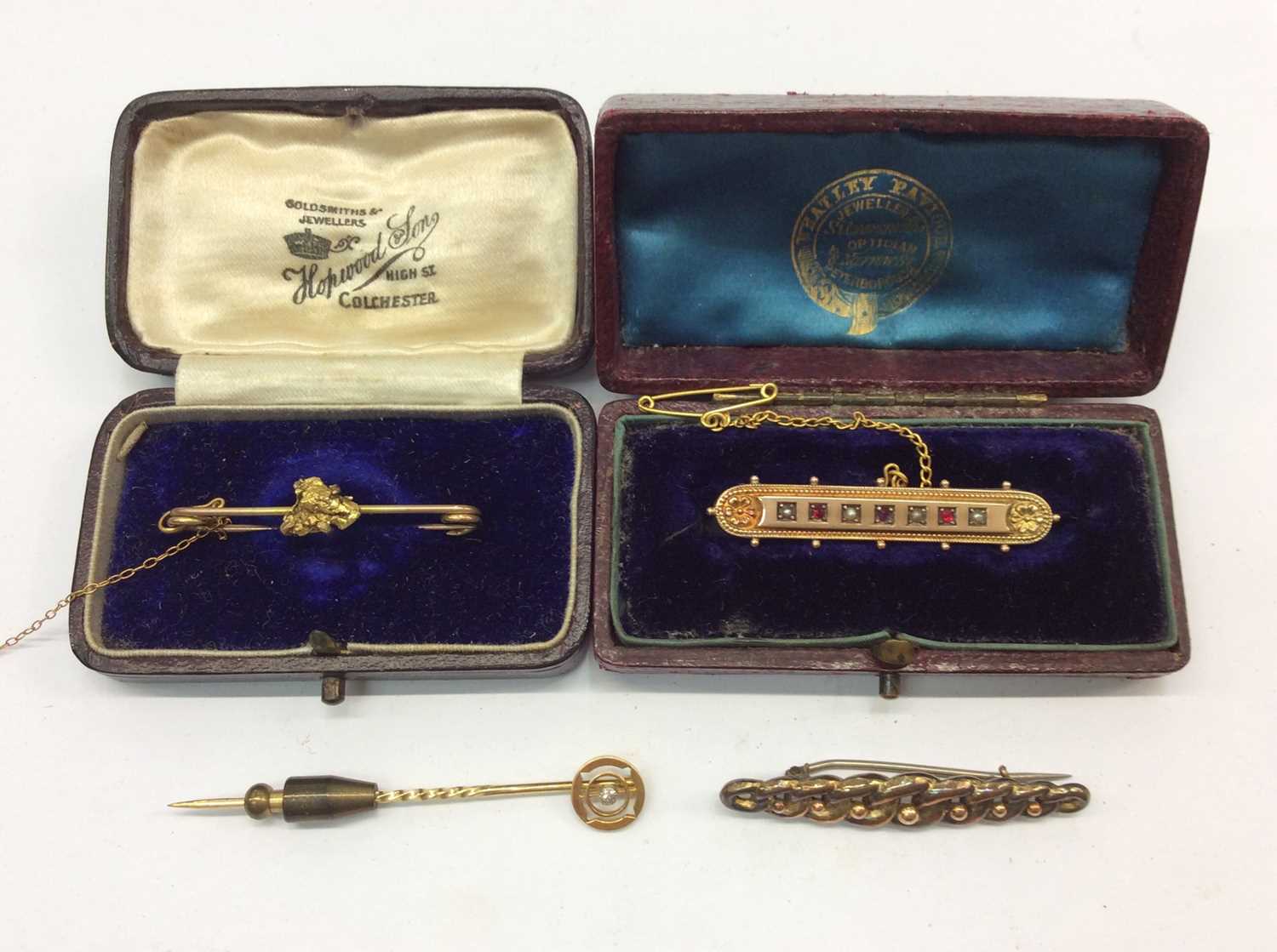 Late Victorian 9ct gold ruby and seed pearl bar brooch, two other bar brooches and 15ct gold stick p