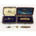 Late Victorian 9ct gold ruby and seed pearl bar brooch, two other bar brooches and 15ct gold stick p