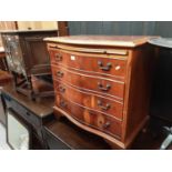 Georgian style yew wood serpentine chest with brushing slide and four drawers below on bracket feet