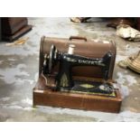 Three vintage sewing machines in cases including Singer