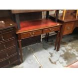 Side table with leather top and spade feet, brass castors.