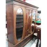 Good quality inlaid mahogany triple wardrobe with central oval panelled door flanked by two oval bev