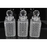 Set of three Edwardian square cut glass decanters, 22.5cm height