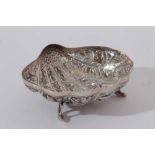 Late 19th / early 20th century Burmese silver dish of shell form, with embossed decoration, raised o