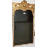 Early 18th century carved gilt wood pier mirror with original bevelled plate, putto cresting and scr