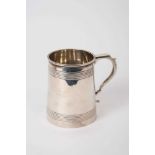 George V silver tankard of tapering cylindrical form, with bands of reeded decoration, scroll handle