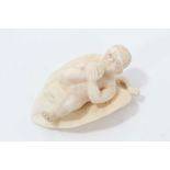 Eastern ivory carving of a child on a leaf