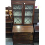 Edwardian inlaid mahogany bureau bookcase with two glazed doors above fall flap and four long drawer