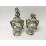 Pair of Coalport style mid 19th century foliate encrusted urns and covers