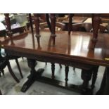 Carved oak drawer leaf dining table on end standards