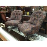Two nursing chairs with purple and multi coloured floral scroll upholstery