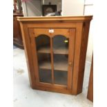 Stained pine hanging corner cabinet with glazed door