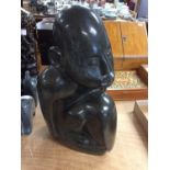 Contemporary carved hard stone male figure with penguin on his lap