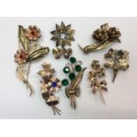 Group seven stylised floral gem set brooches, all stamped sterling and pair clip on earrings