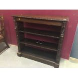 Victorian carved oak open bookcase with two shelves and human mask and fruit decoration 101cm wide,