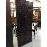 Ercol style oak corner cabinet with leaded glazed doors and two panelled doors below