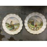 Pair of early 20th century Royal Crown Derby painted porcelain plates by W. E. J. Dean, with titled