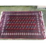 An old Bokhara rug on red and blue ground, 167cm x 126cm