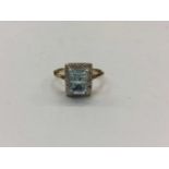 Yellow metal blue topaz and diamond dress ring