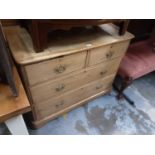 Antique pine chest of two short and two long drawers with brass handles