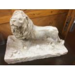 Plaster sculpture of a lion, on naturalistic base, 46cm long