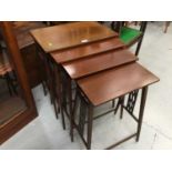 Nest four Edwardian inlaid mahogany coffee tables with pierced end supports