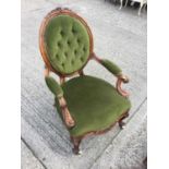 Victorian Walnut framed arm chair with carved scroll arms and green velvet upholstery on cabriole le