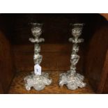 Pair of ornate Victorian silver plated candlesticks with scroll decoration