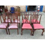 Set of four Reproduction Chippendale style dining chairs on claw and ball feet with pink velvet upho