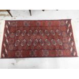 Eastern rug with geometric decoration on red ground, 157cm x 86cm