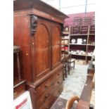 Victorian mahogany linen press enclosed by two doors with drawers below