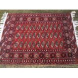 An old Bokhara rug on red and blue ground, 188cm x 124cm