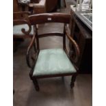 Two Regency elbow chairs with scroll arms and