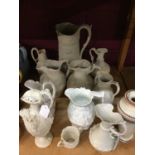 Collection of Victorian relief moulded white glazed jugs, together with first period Belleek jug