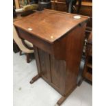 Late Victorian oak school desk with cupboard to reverse, together with oak tub desk chair