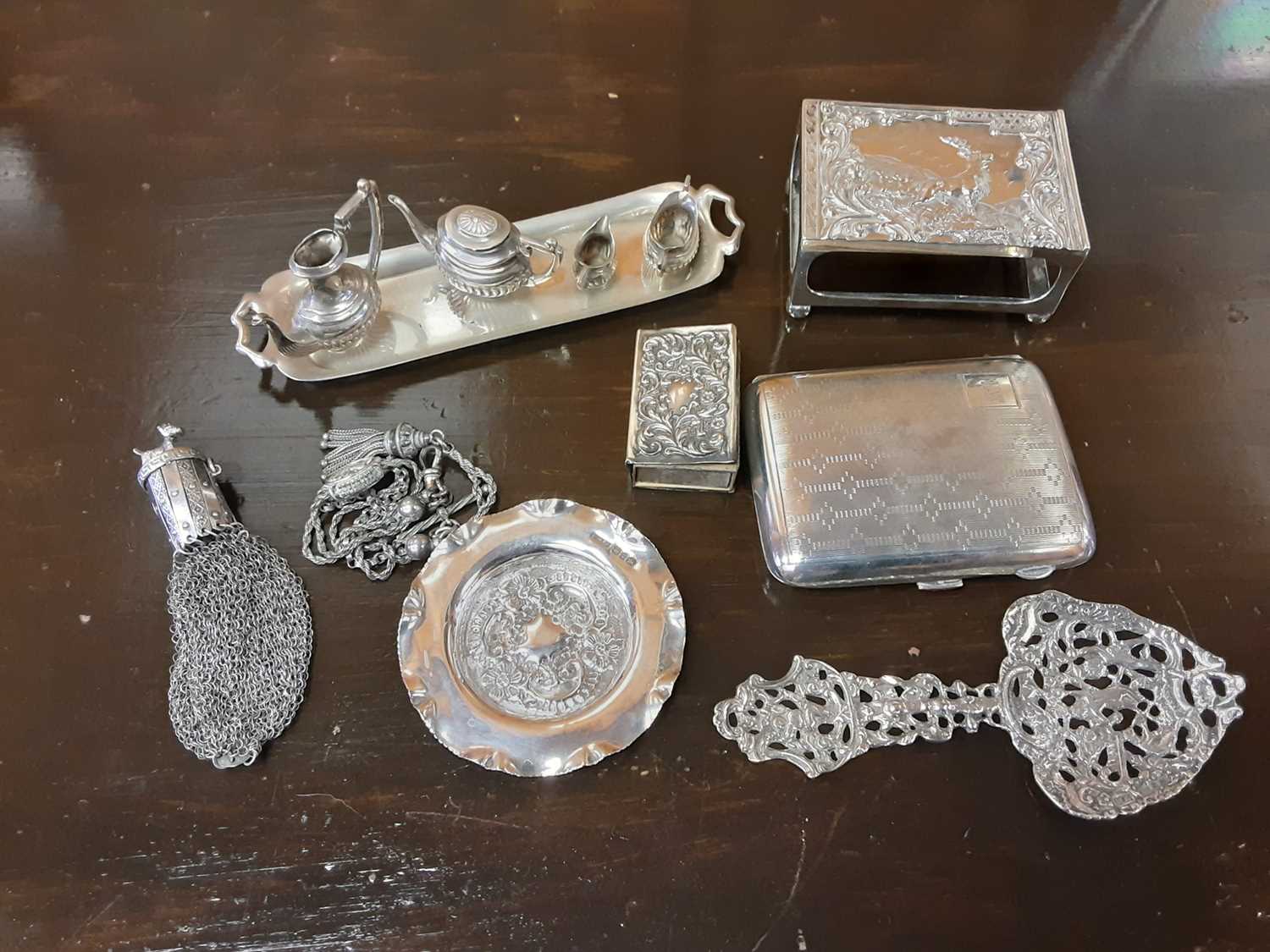 Group of assorted silver items to include a cigarette case, misers purse, miniature tea set and matc