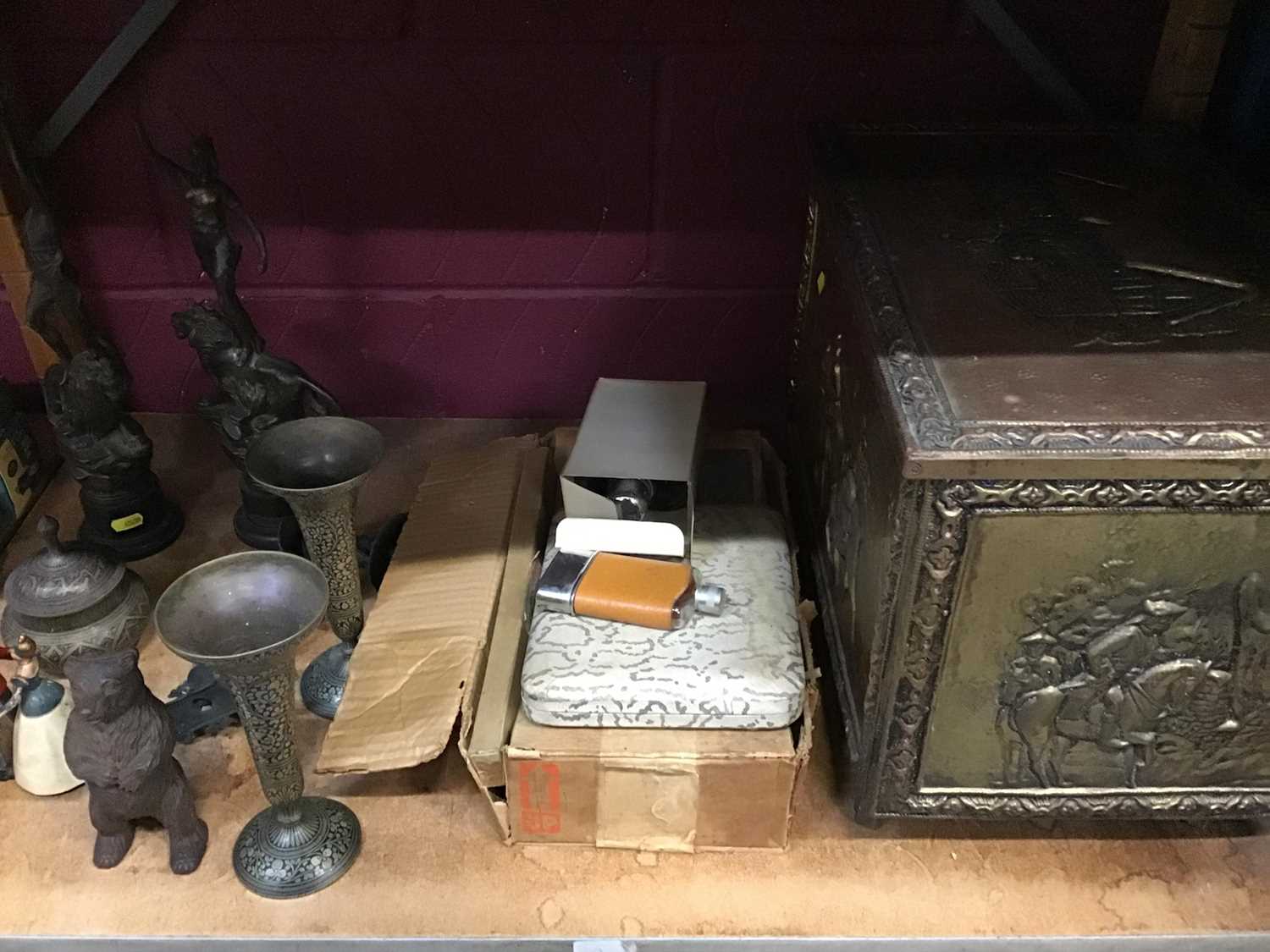 An embossed brass log box, metal ware including Black Forest style money box and flatware