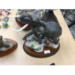 Franklin Mint porcelain figure of an elephant, together with another of a Rhino (2)