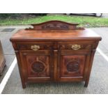 Edwardian carved walnut cheffonier with ledge back two draws above two panelled doors