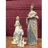 Large Lladro figure of a mother cradling a baby, and two other similar figures