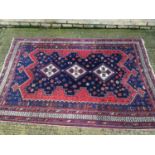 An old Afshar rug on red and blue ground, 242cm x 170cm