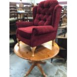 Contempory wing easy chair with red upholstery and pine circular breakfast table