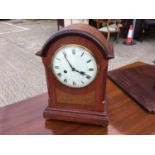 Victorian walnut cased mantel clock with white enamel dial