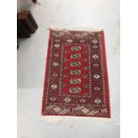 Four small Eastern rugs with geometric decoration