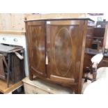 Edwardian inlaid mahogany bowfront cupboard enclosed by two panelled doors