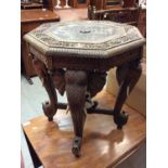 Good quality Eastern carved occasional table with octagonal top and four elephant head supports