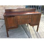 1920's Mahogany sideboard with two central draws, and cupboard to sides, ledge back and label to rev