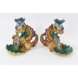 Pair of Cantagalli maiolica candlesticks, in the form of heraldic dragons with scallop shell bowls,