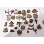 Group of First World War and later military cap badges, two silver war badges and various military a